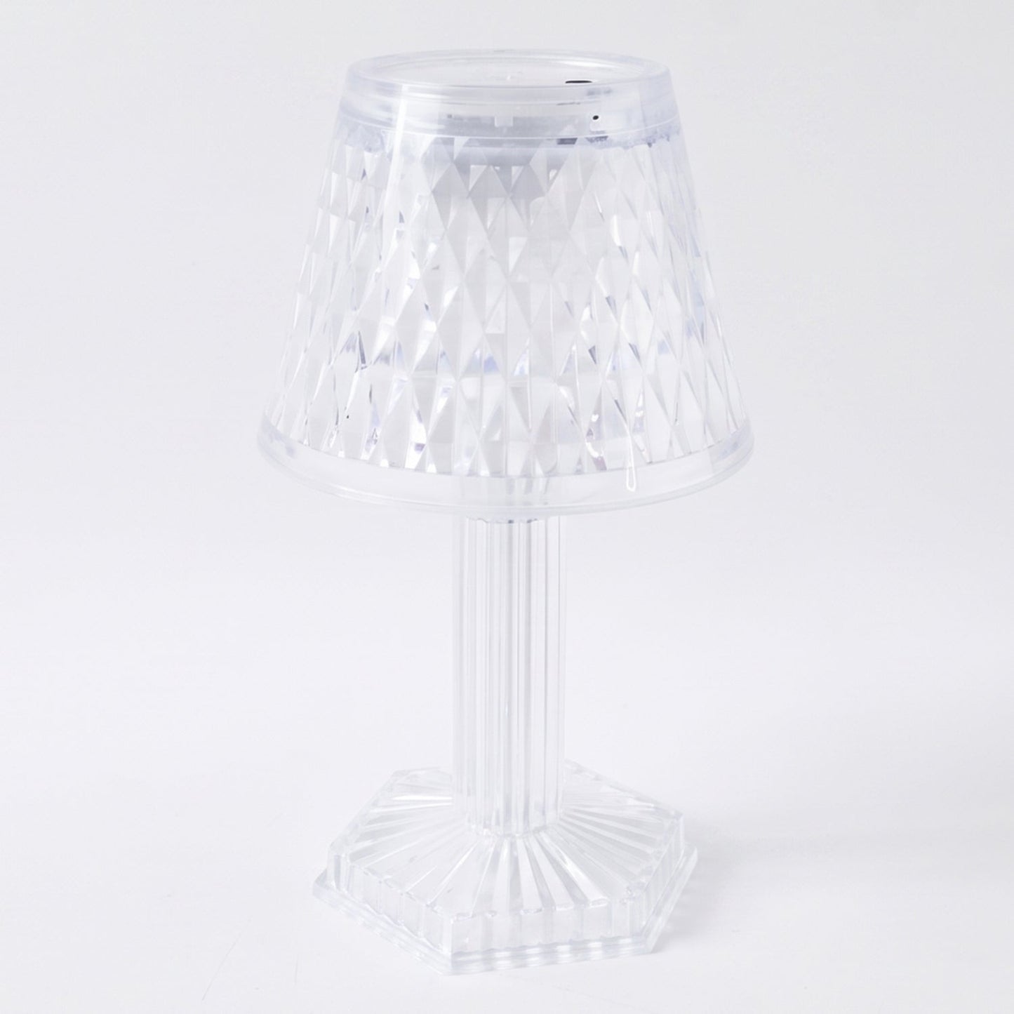 Modern LED crystal lamp displayed on a wooden shelf in a home setting.