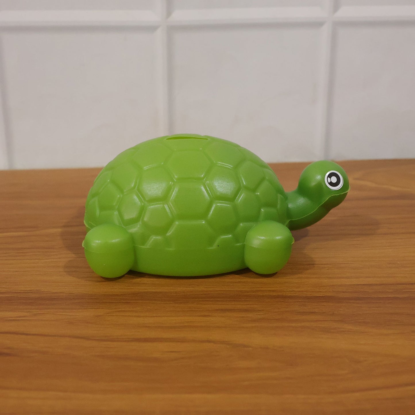 Tortoise money bank in kids room setting