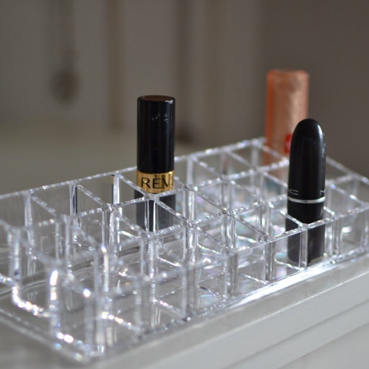 Close-up of the acrylic lipstick holder, showcasing the clarity and design of the 24 organized sections.