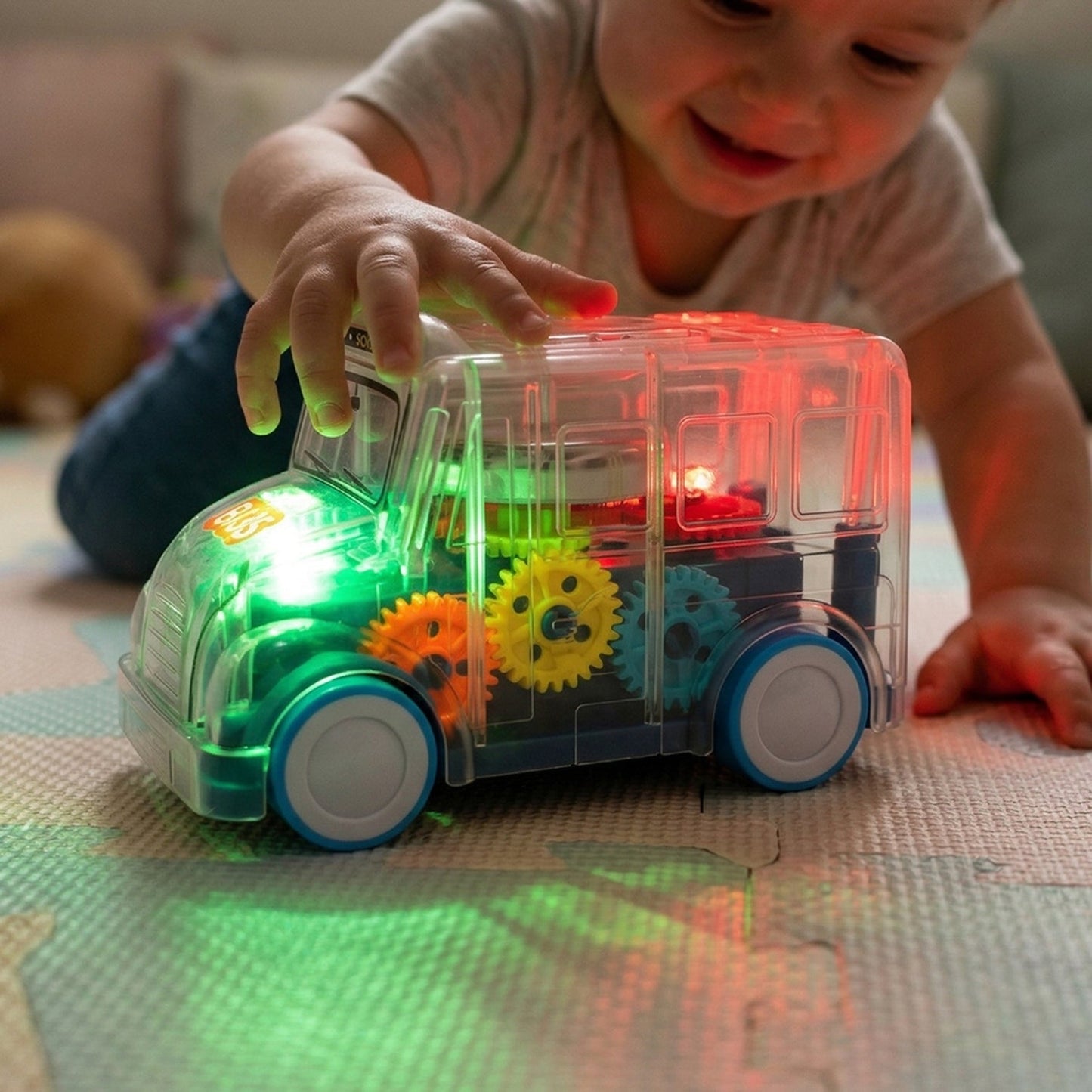 Transparent school bus toy with moving lights and music
