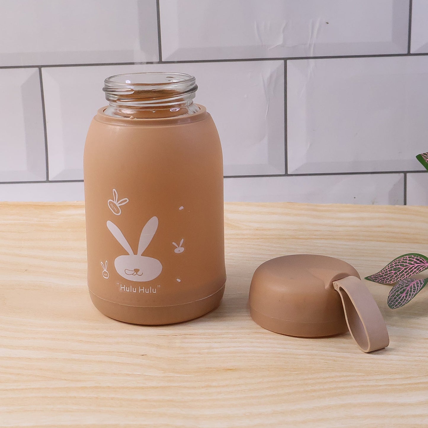 Glass bottle displaying brown bunny print with secure lid