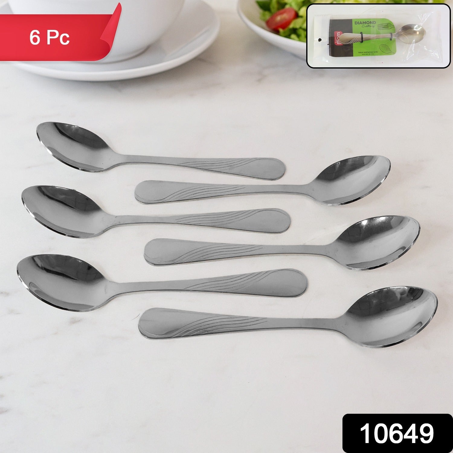 Stainless steel spoons neatly arranged on a white background, showcasing their polished finish