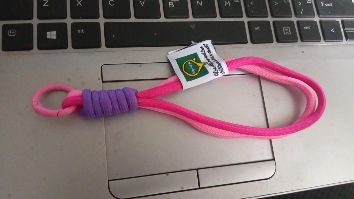 Securely attached multi-color wrist strap lanyard on a smartphone, preventing drops.