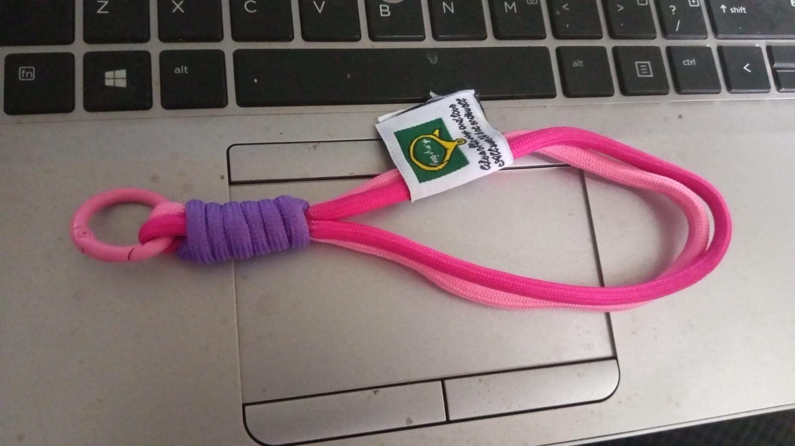 Securely attached multi-color wrist strap lanyard on a smartphone, preventing drops.