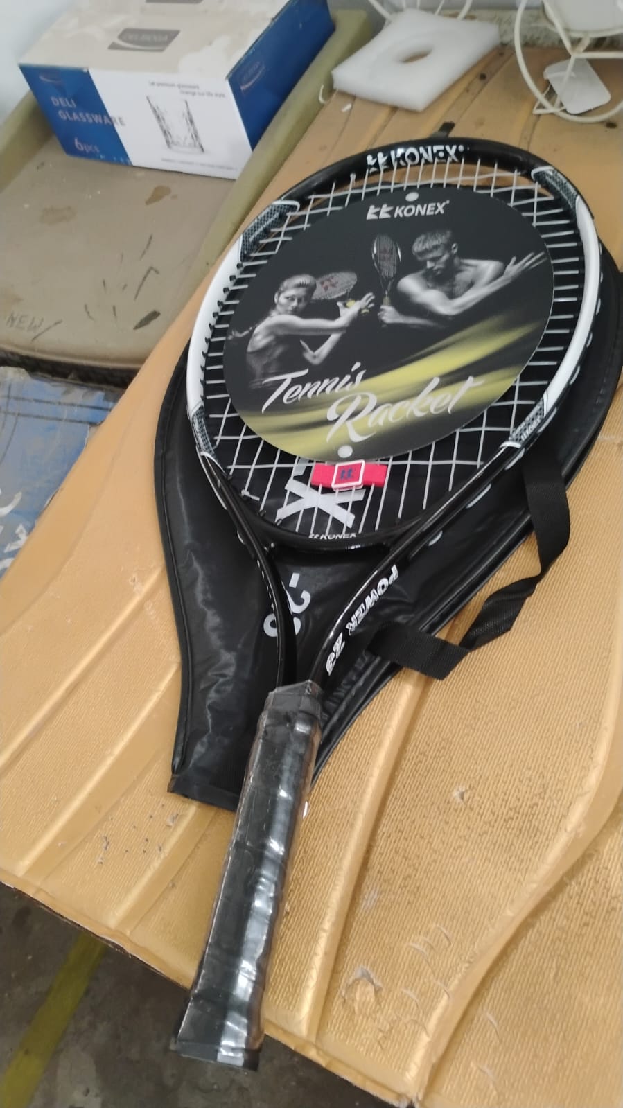 Angled studio shot of lightweight tennis racket showcasing frame design
