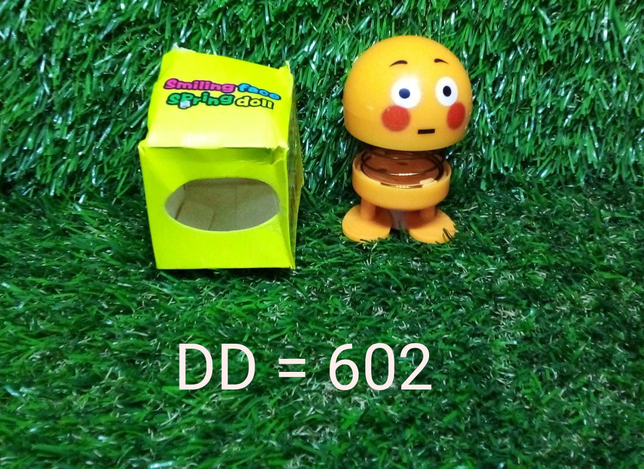 Smiling face spring figure toy with its adhesive base visible, ready for secure placement.