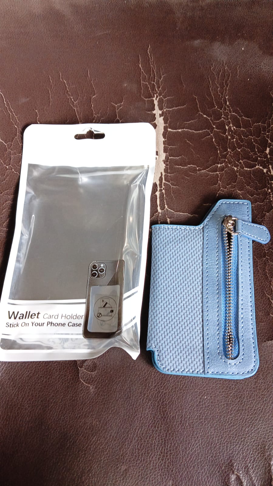 Slim profile of the adhesive phone wallet holder attached to a phone.