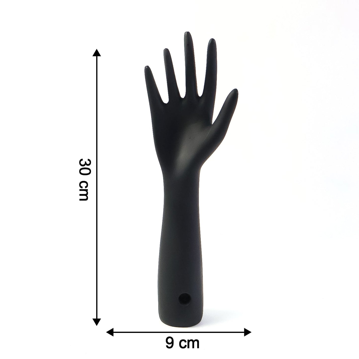 Black hand jewelry display stand placed on shelf for accessories