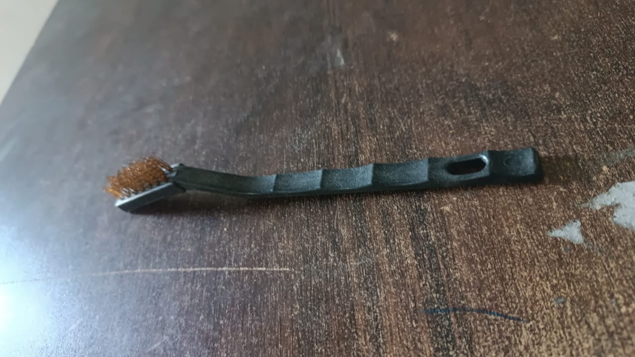 Assortment of cleaning tools including the mini brass wire brush for various tasks.