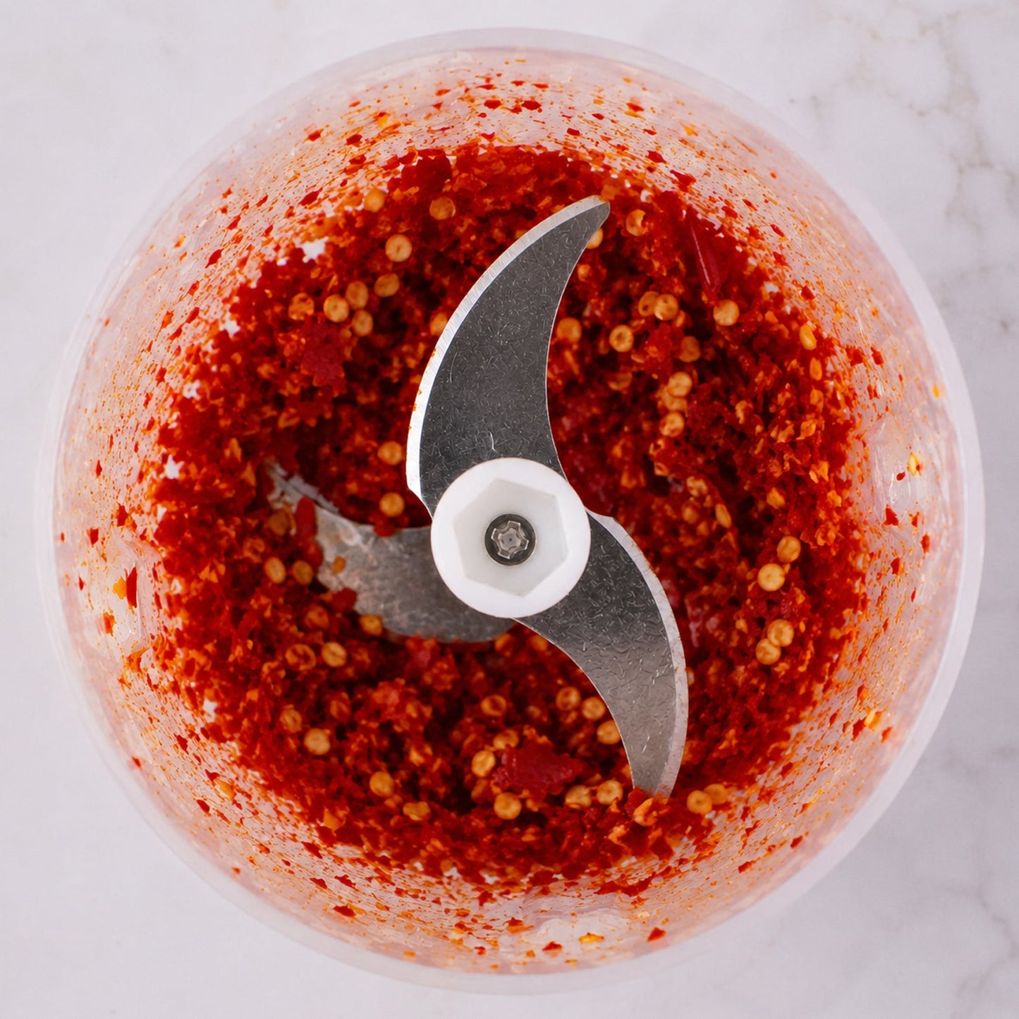 Chili inside stainless steel blade of garlic chopper