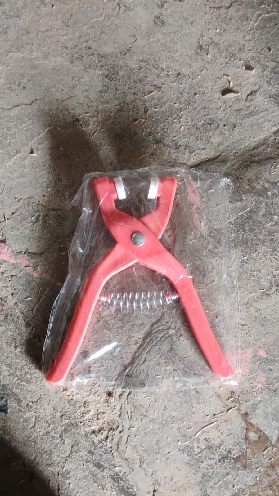 Multiple eyelets and the eyelet pliers demonstrating their versatility on different fabrics.