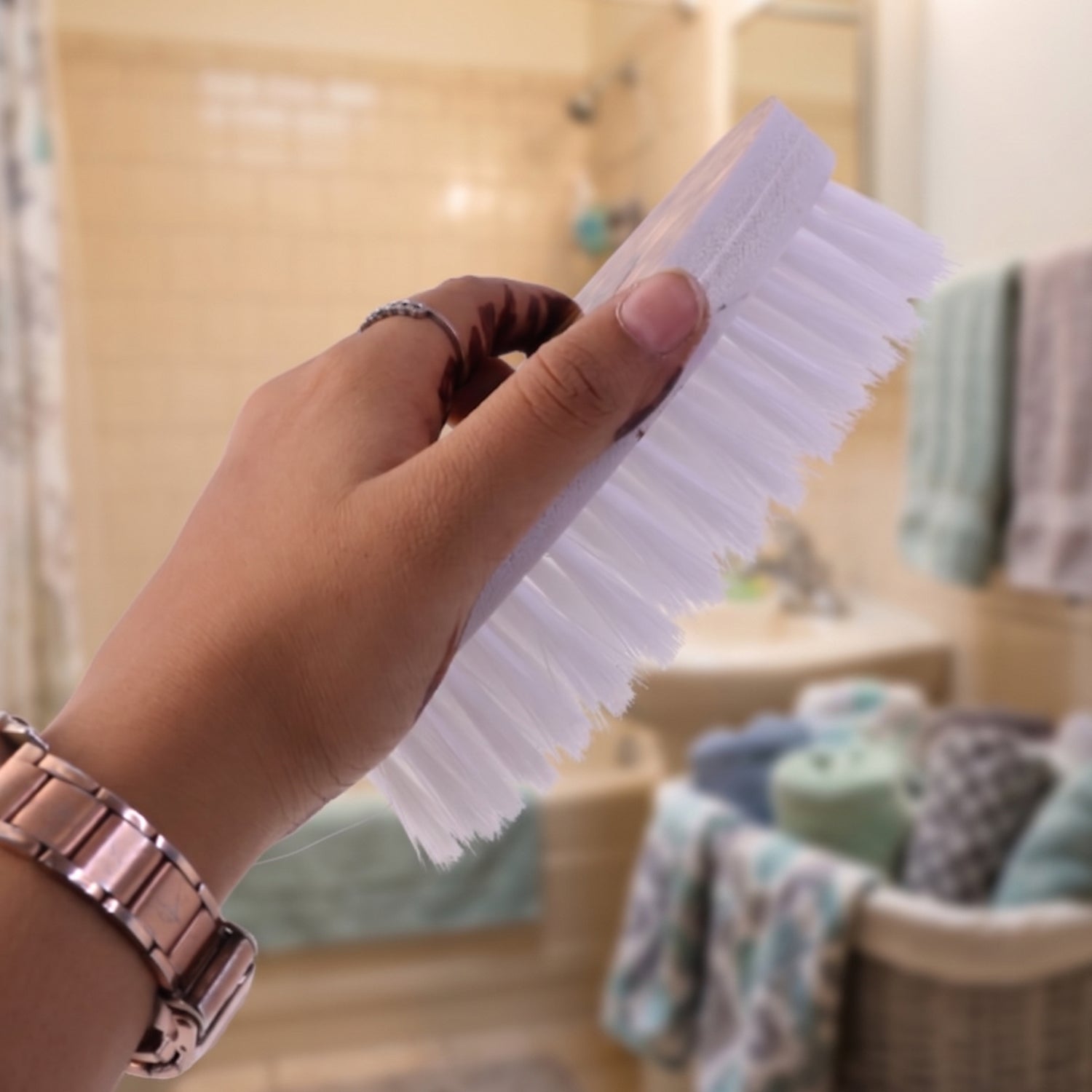 Durable plastic and nylon bristle cloth washing brush with ergonomic oval shape.
