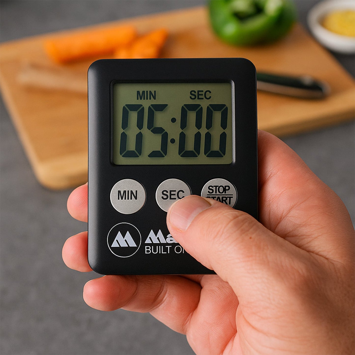 Versatile digital timer standing on a kitchen countertop with its built-in kickstand.