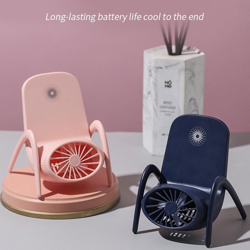 Multi-function fan used as a desk fan, cooling a person working on a laptop.