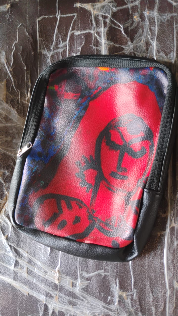 Glimmerly multi-purpose storage bag being placed into a larger handbag.
