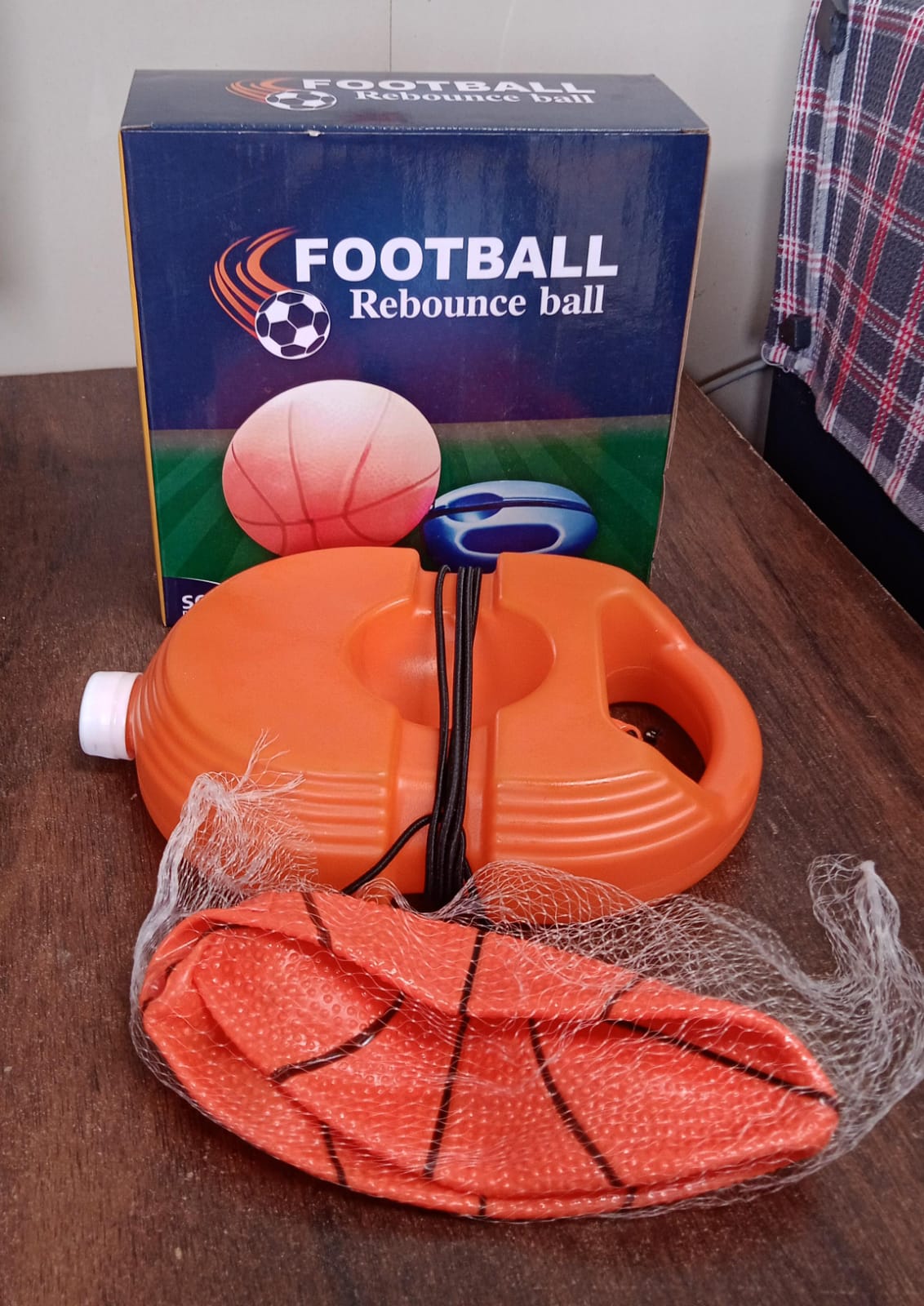 Detailed setup of the Football Rebounder, showing the ball, string, and weighted base for practice.