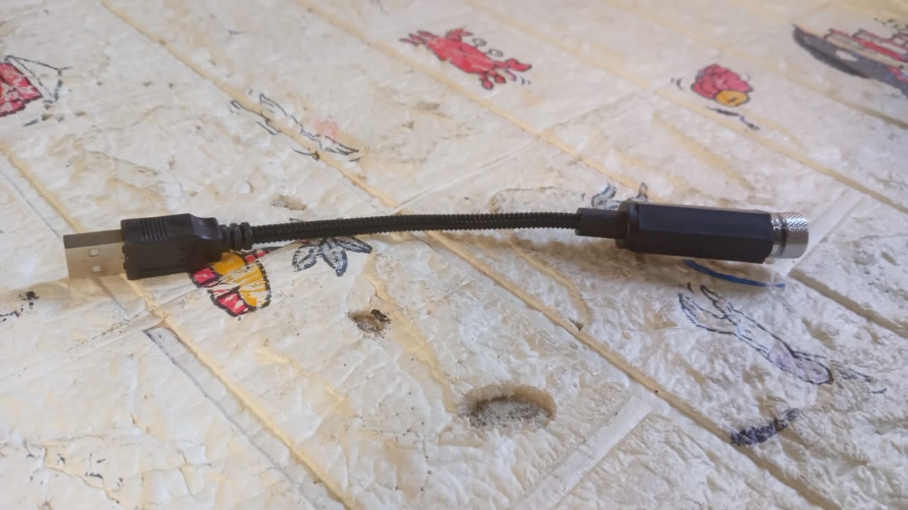 Versatile sky effects projector illuminating a dark space with stars.