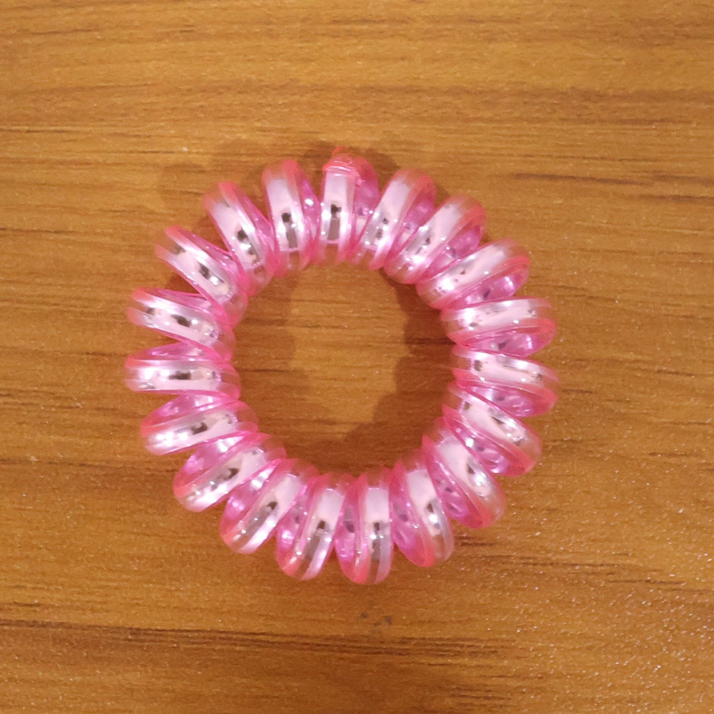 Group of mixed color spiral hair ties on a white background