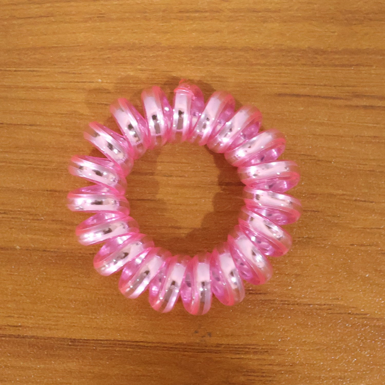 Group of mixed color spiral hair ties on a white background