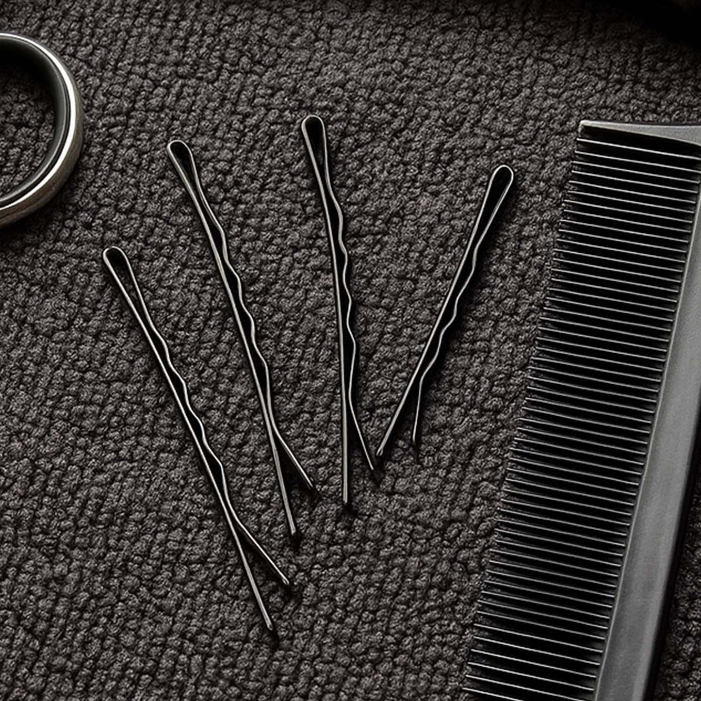 Detailed close-up of black bobby pin with smooth tips