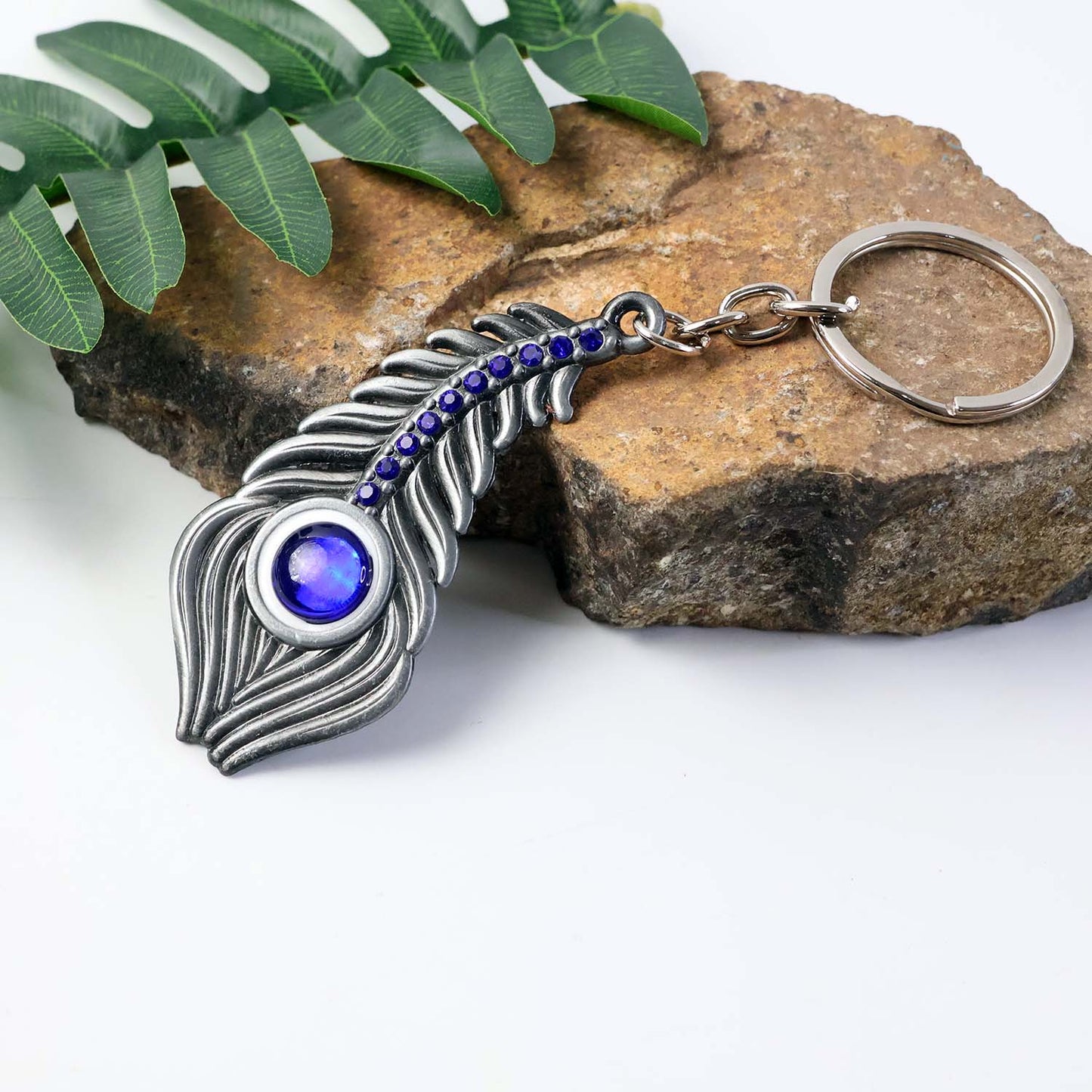 Close-up image showing peacock eye design on metal keychain