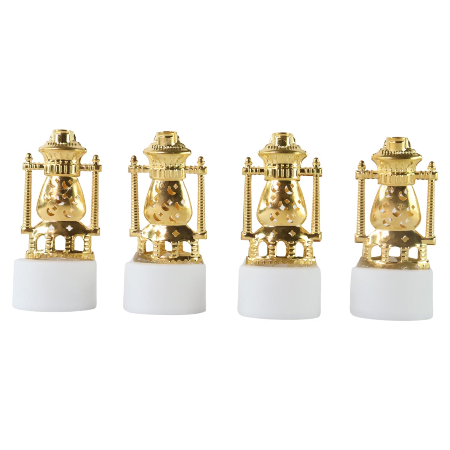 Three vintage lantern-style flameless LED tealights glowing in a dark setting.