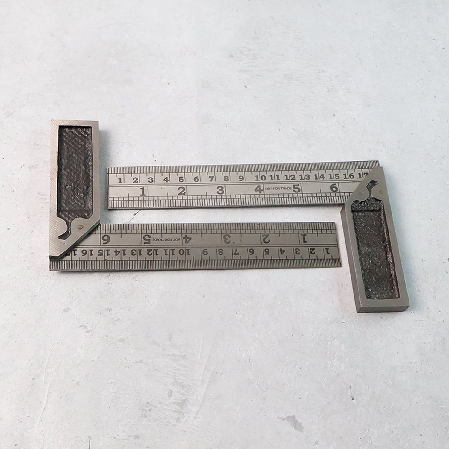 Two-piece metal try square ruler set showing accurate etched inch and centimeter measurements
