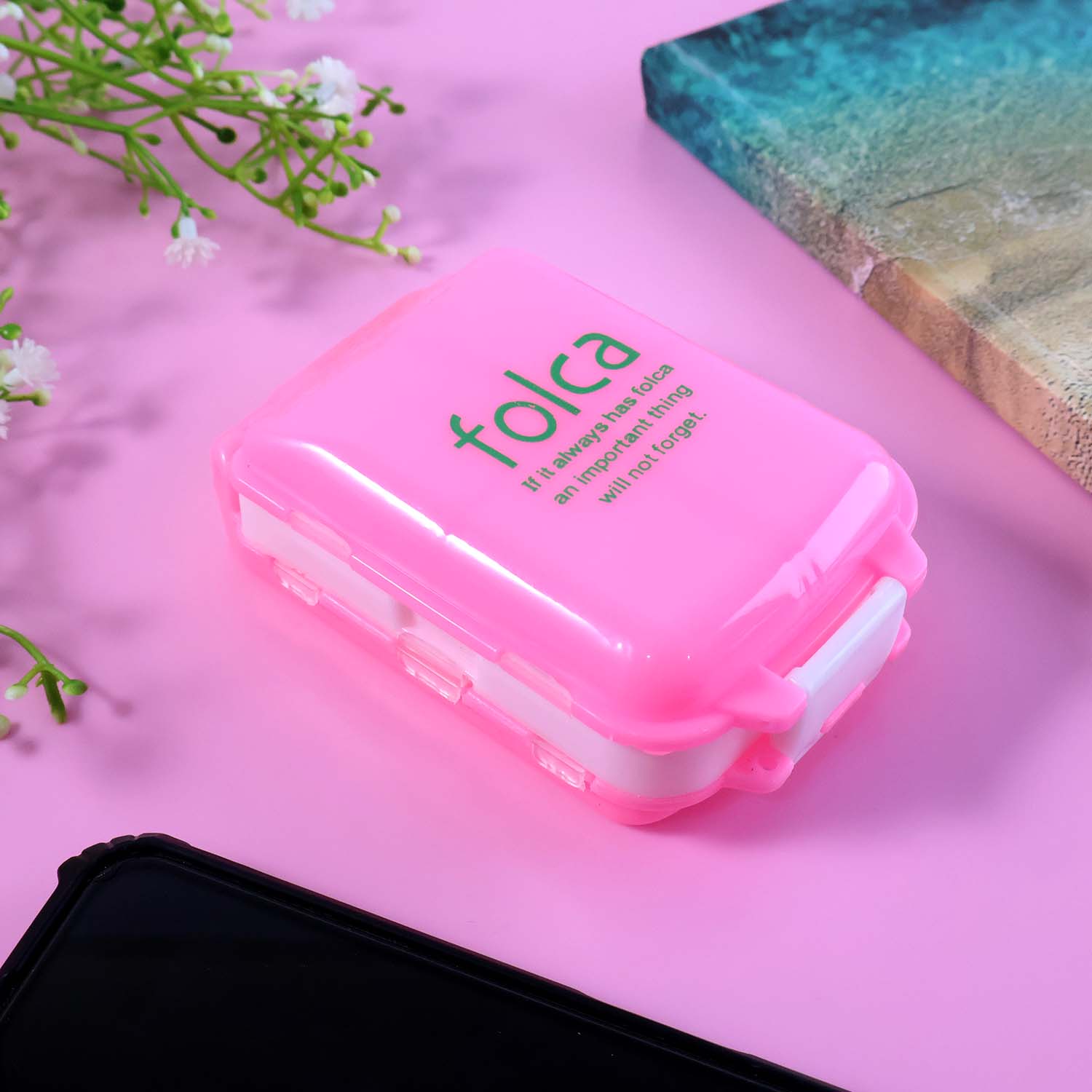 Organizer box compartments filled with tablets and vitamins