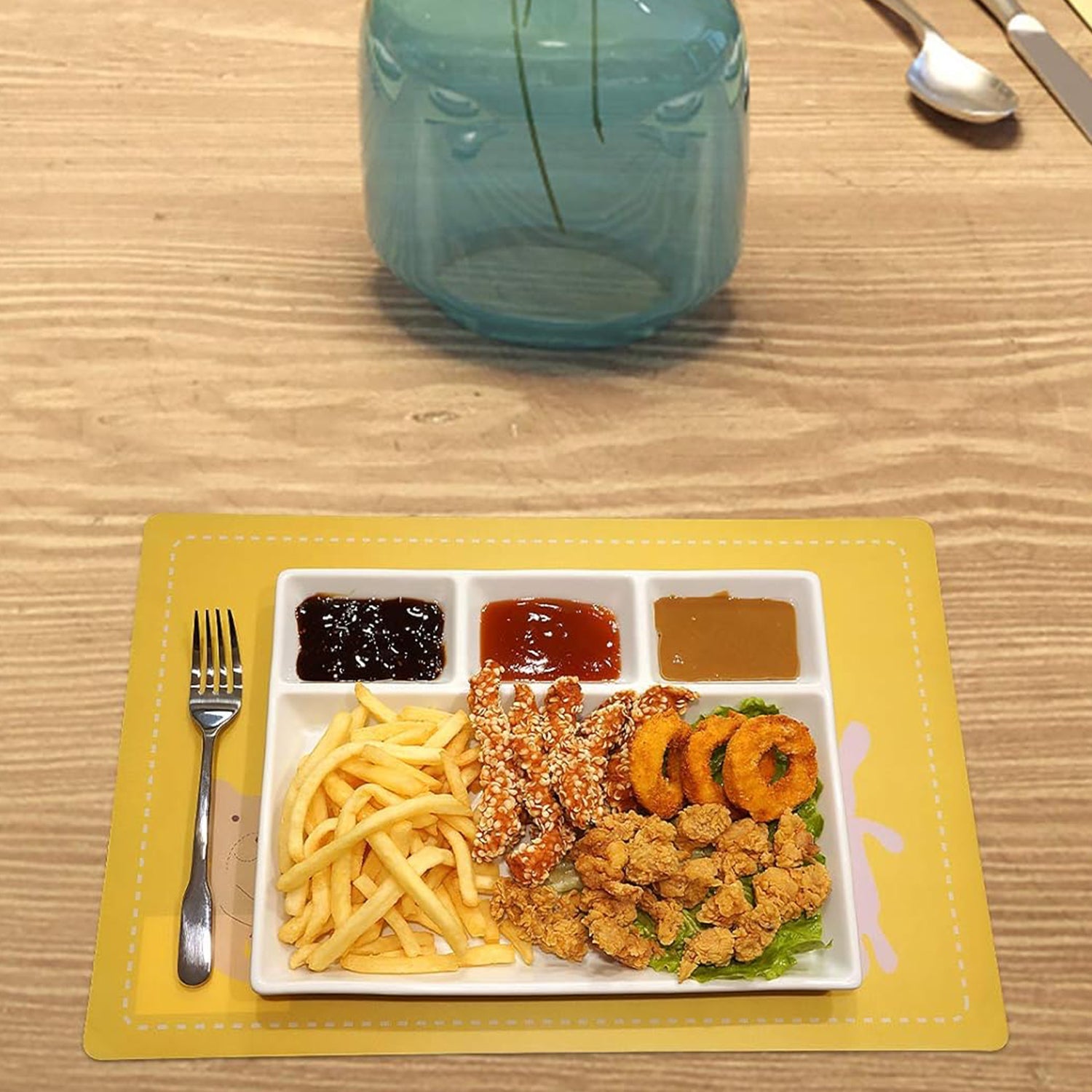 Divided plastic meal tray with raised edges preventing spills.