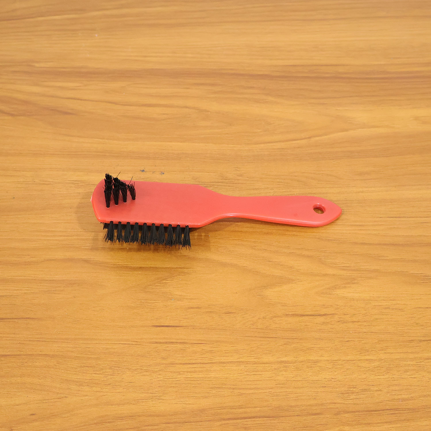 Shoe cleaning brush in use cleaning sneakers to remove dirt and stains