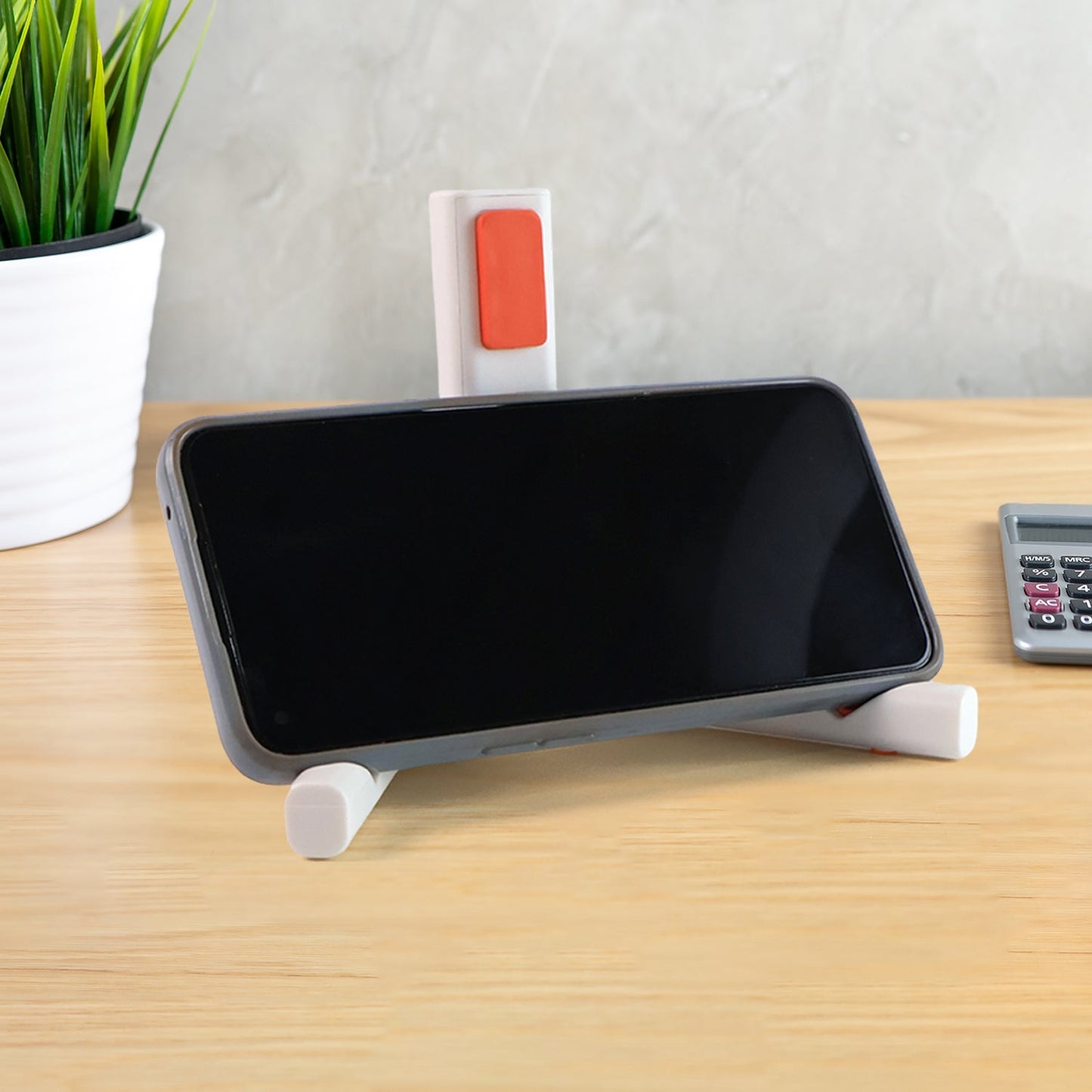 Foldable mobile phone and tablet stand with non-slip base for secure device placement.