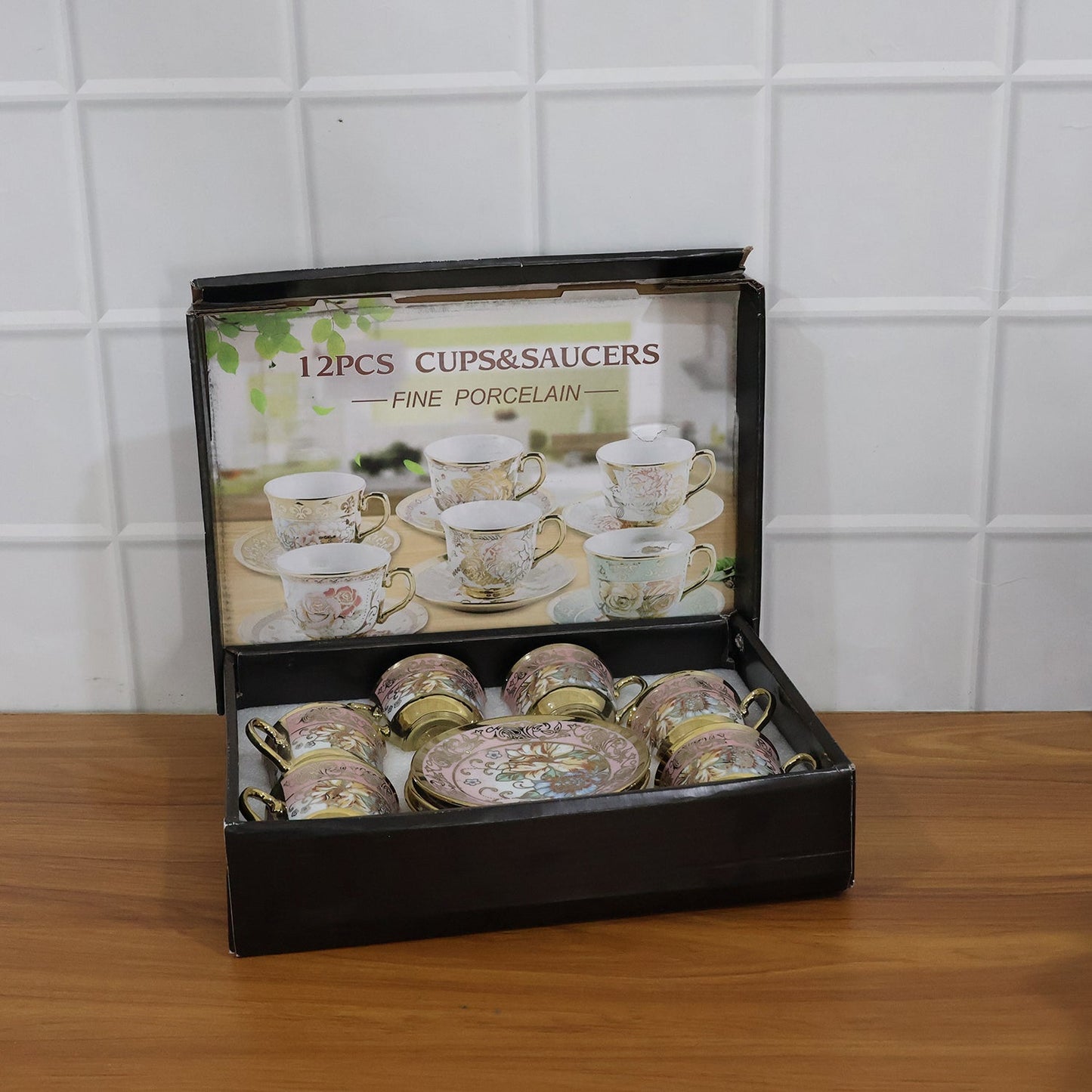 Tea cup and saucer set featuring classic floral design with gold accents