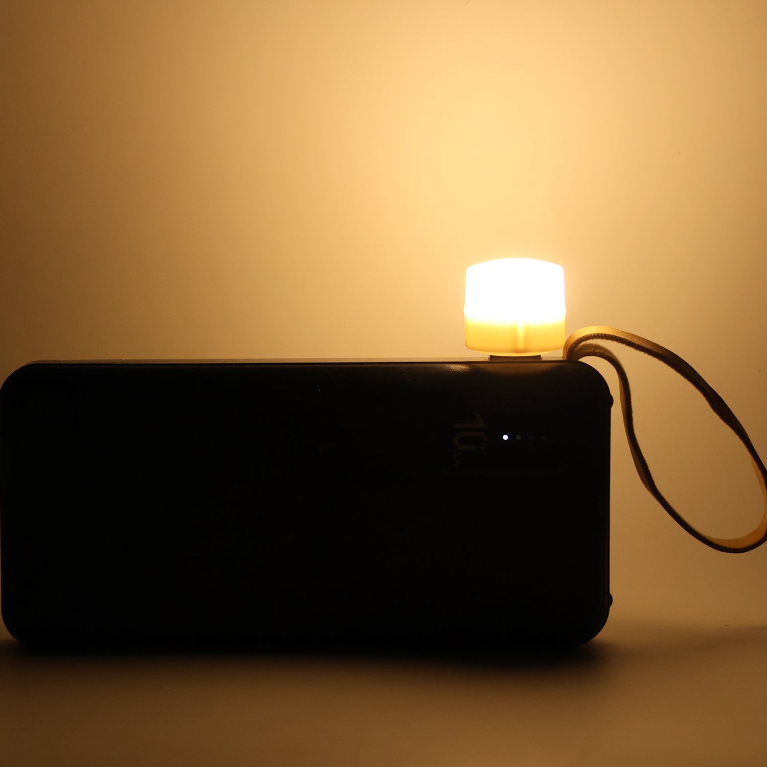 Close-up of warm yellow USB LED night light on a laptop keyboard